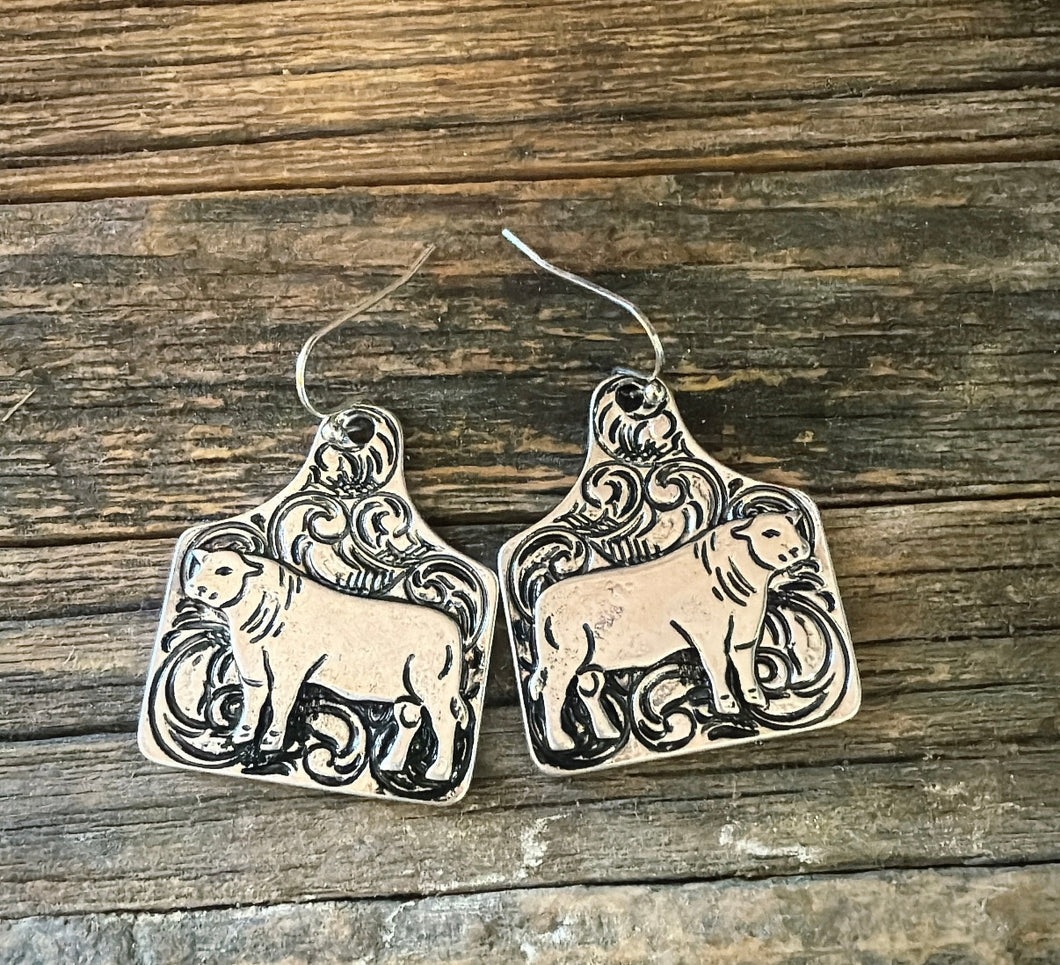 Tooled tag bull earrings